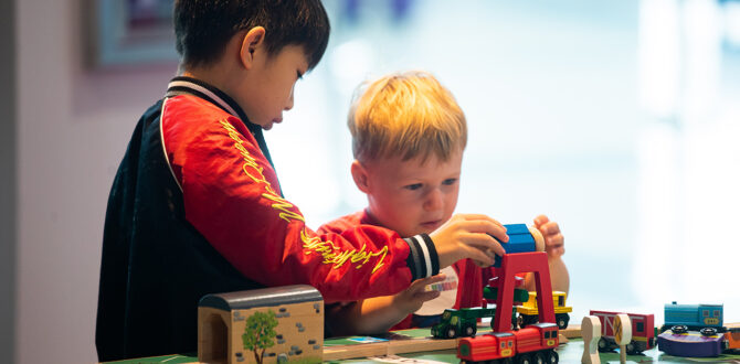 Two young boys play with wooden trains at Qubein Children's Museum.