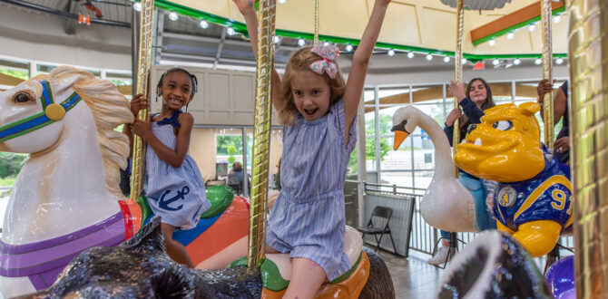 Children ride carousel.