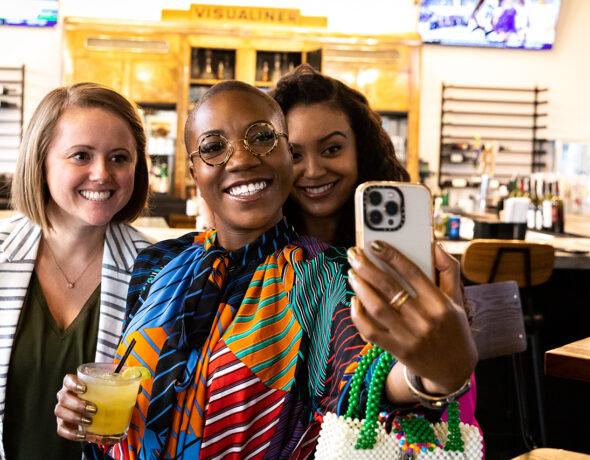 Group of three women takes a selfie.