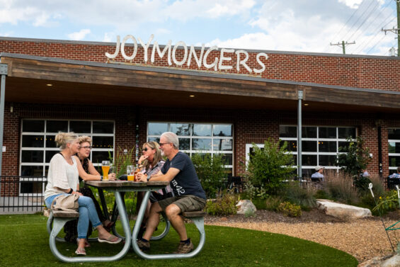 People have a drink at Joymongers, a popular brewery in Greensboro