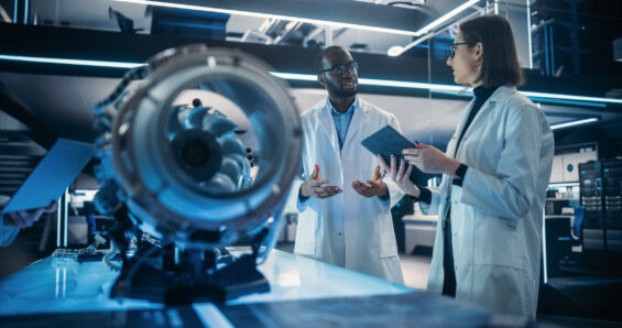 A man and a woman discuss an engine turbine