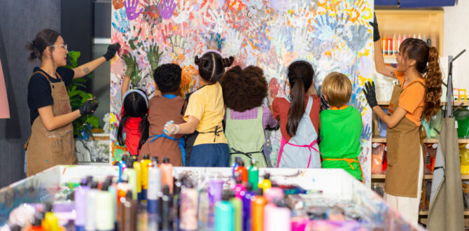 Children creating art at school with painted hand prints