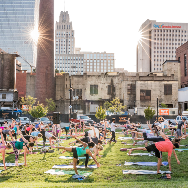 Large outdoor yoga class in downtown Winston-Salem.