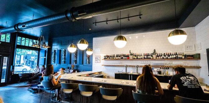 People sitting at wine bar counter.