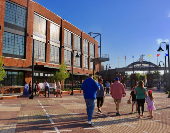 People walking towards stadium.