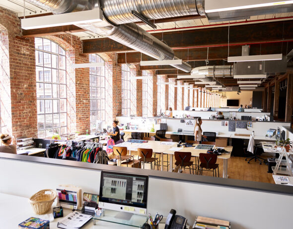 Clothing designers work in open-concept office space.