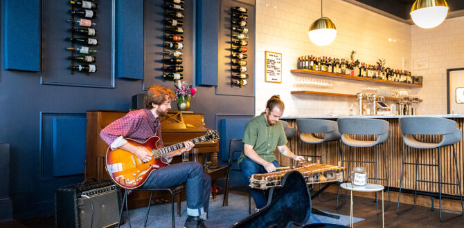 Two musicians perform at local wine bar.