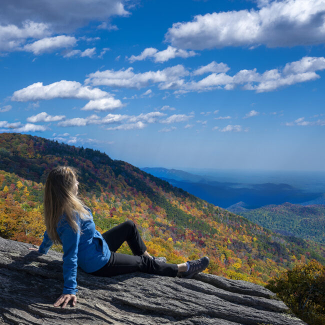Woman relaxing at the top of a mountain in the Blue Ridge Mountains.